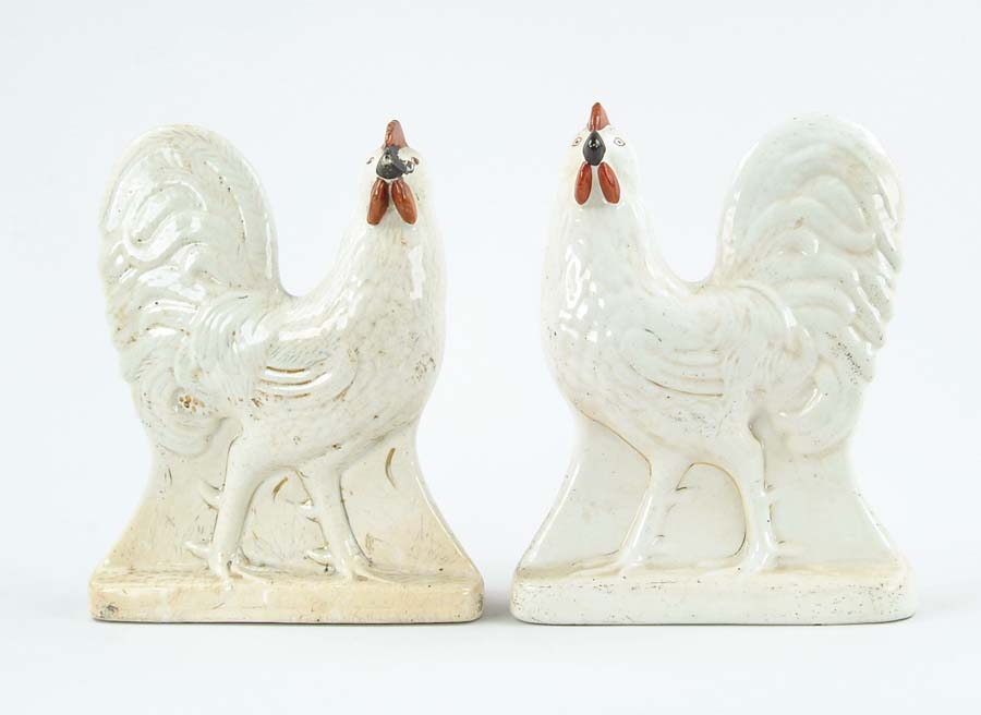 Appraisal: PAIR OF STAFFORDSHIRE STANDING COCKERELS Figures face different directions They