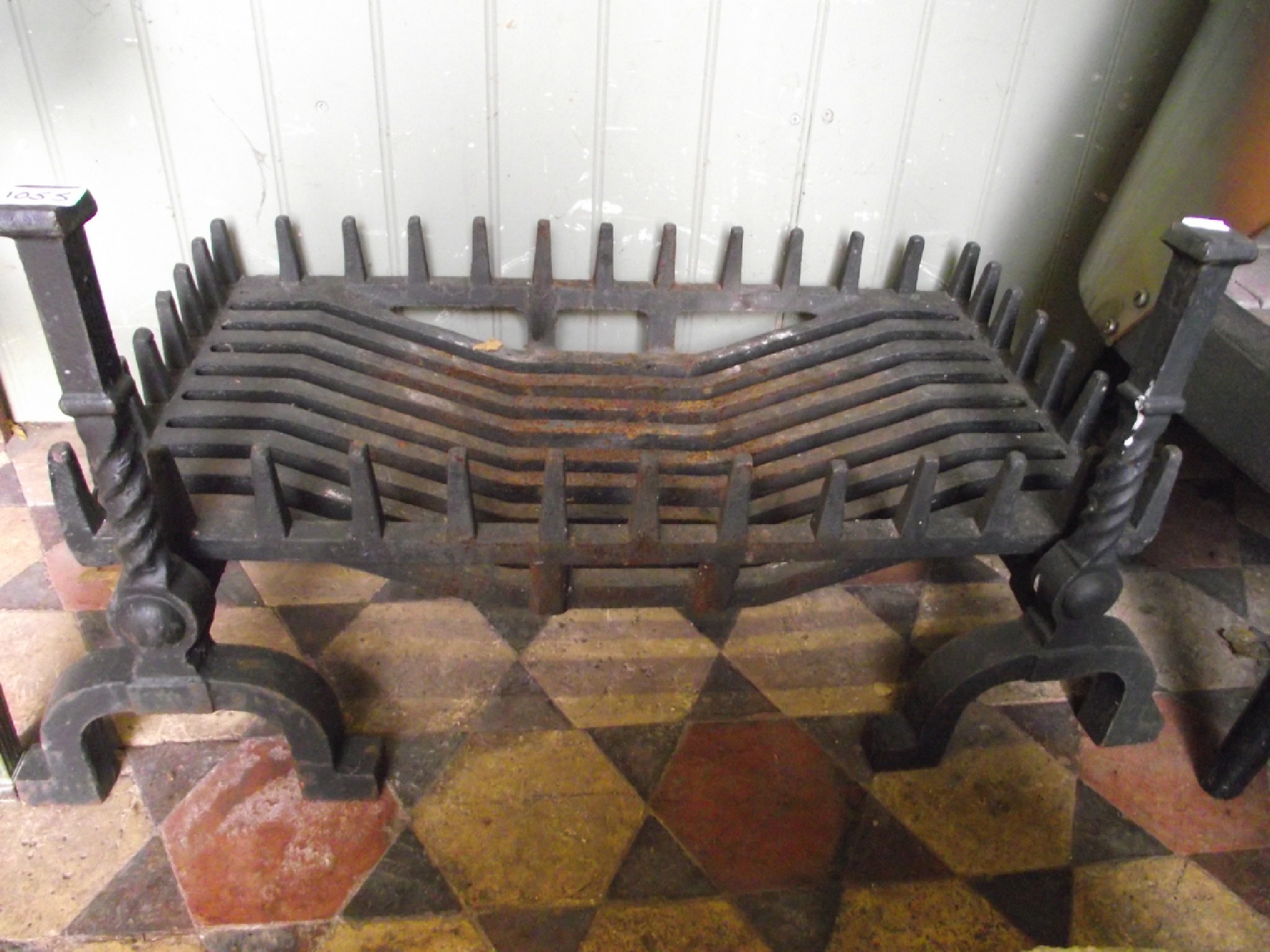 Appraisal: A heavy cast iron fire grate basket raised on a