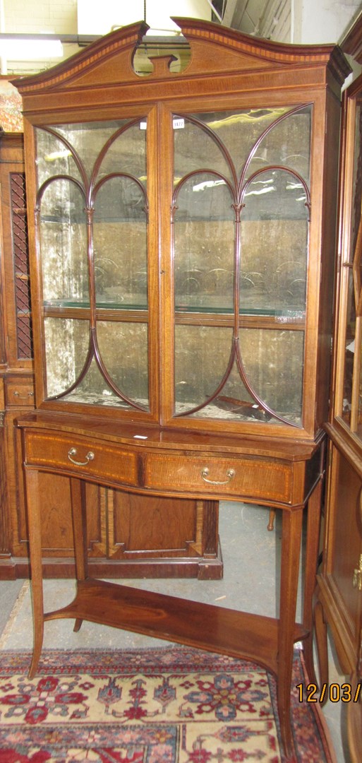 Appraisal: An Edwardian inlaid mahogany two door display cabinet on a