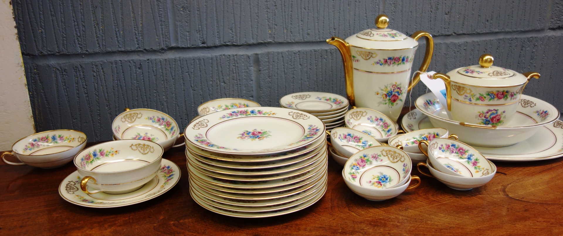 Appraisal: A Limoges porcelain coffee and tea service decorated with flowers