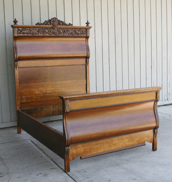 Appraisal: Carved oak high back bed floral trim across headboard curved