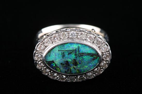 Appraisal: K WHITE GOLD BLACK OPAL AND DIAMOND RING Elongated oval