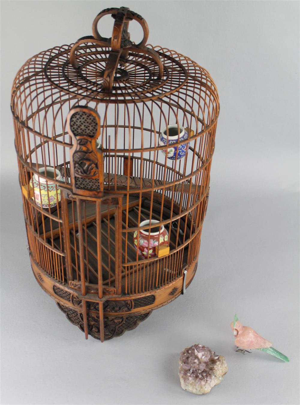 Appraisal: ASIAN BIRDCAGE WITH CARVED DECORATIONS with four porcelain mounted vessels