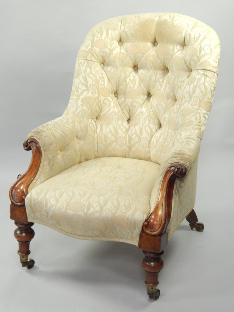 Appraisal: A Victorian mahogany button back upholstered armchair on turned legs