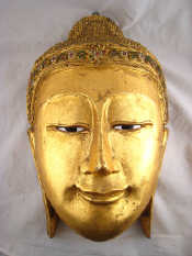 Appraisal: A large wall mounted well carved wooden Buddha's head covered