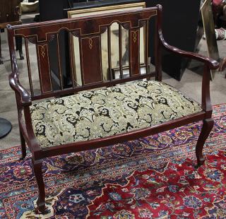 Appraisal: Edwardian mahogany settee Edwardian mahogany settee the highly figured back