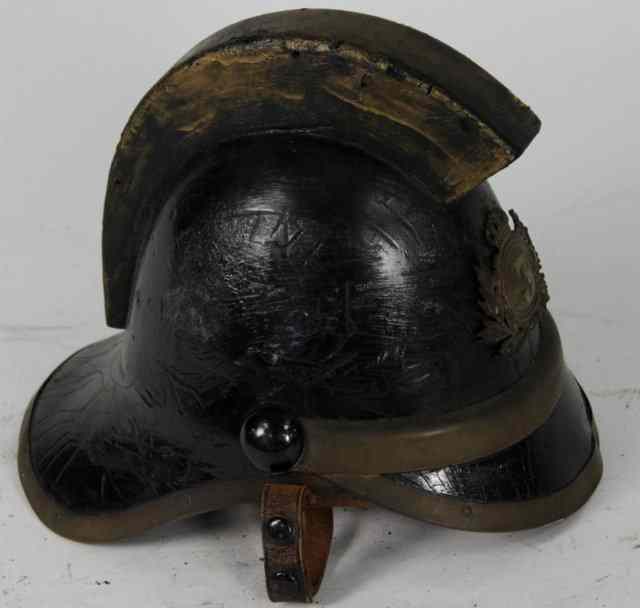 Appraisal: A fireman's leather helmet with badge No