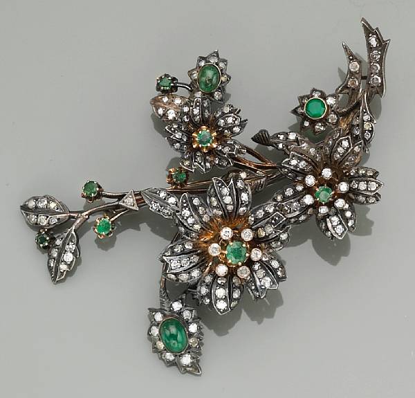 Appraisal: A diamond and emerald articulated brooch mounted in silver-topped gold