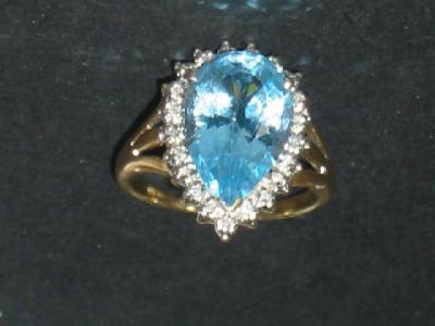 Appraisal: A LARGE BLUE TOPAZ DRESS RING the pear cut topaz