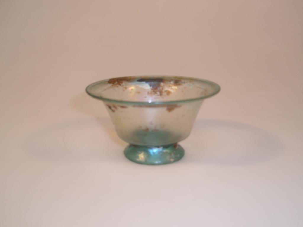 Appraisal: A small Roman footed bluish-green glass bowl the everted mouth