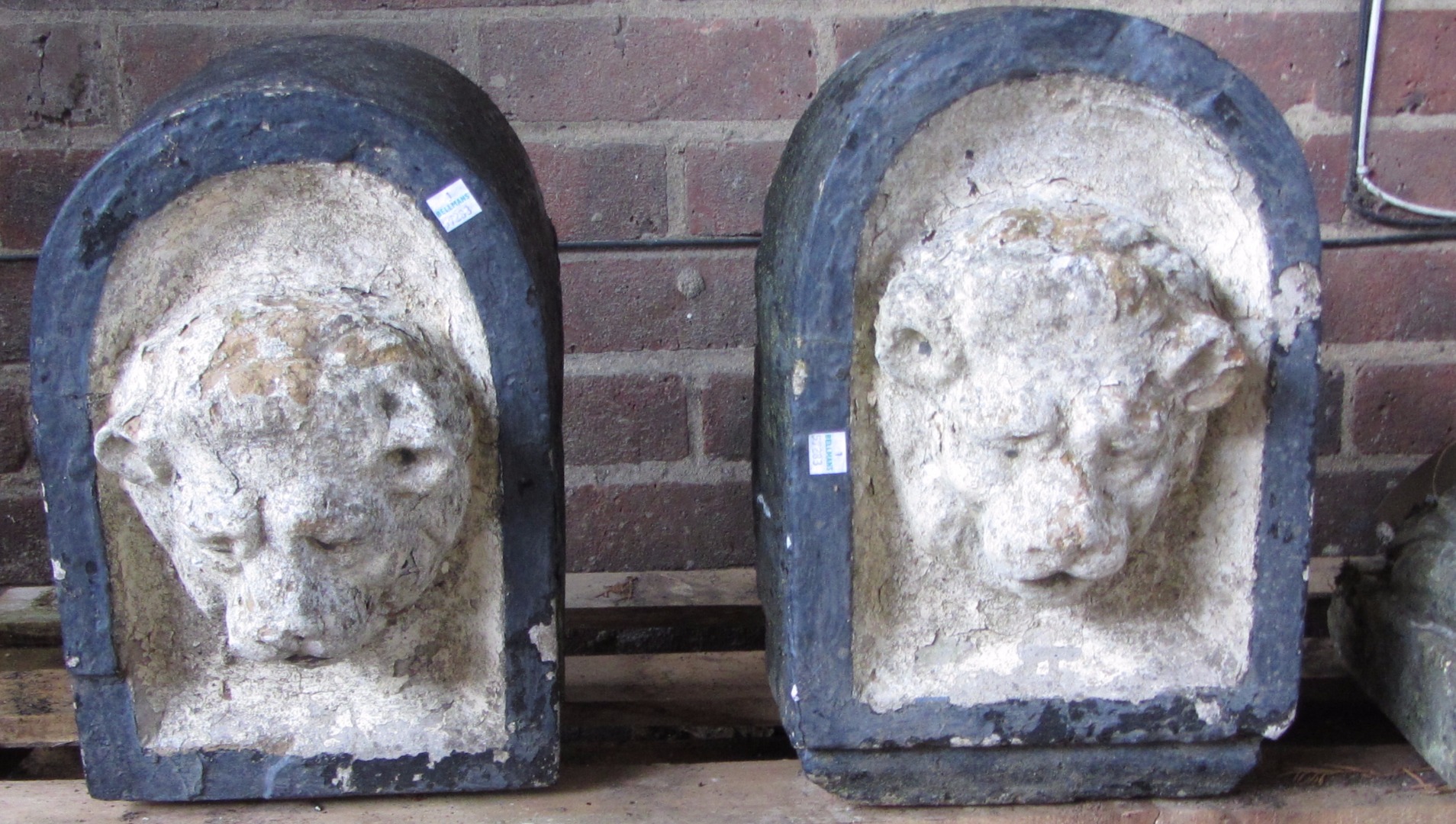 Appraisal: A pair of carved stone corbels depicting lions within arches