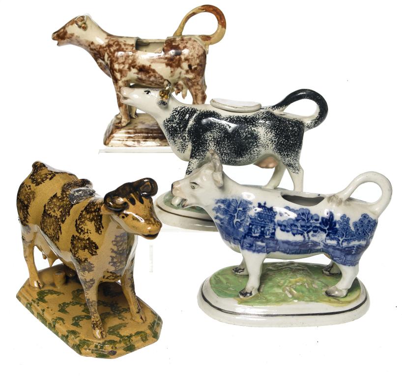 Appraisal: A STAFFORDSHIRE CREAMWARE COW AND CALF COW CREAMER on stepped