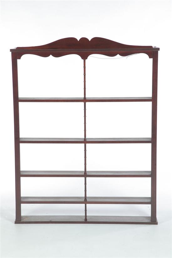 Appraisal: HANGING SHELF Twentieth century mahogany Scroll-cut pediment turned central post