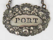 Appraisal: A Georgian sterling silver wine label with original chain pierced