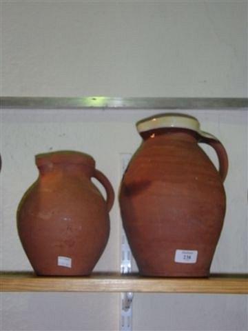 Appraisal: A BRANNAM POTTERY OF DEVON HANDLED JUG the top rim