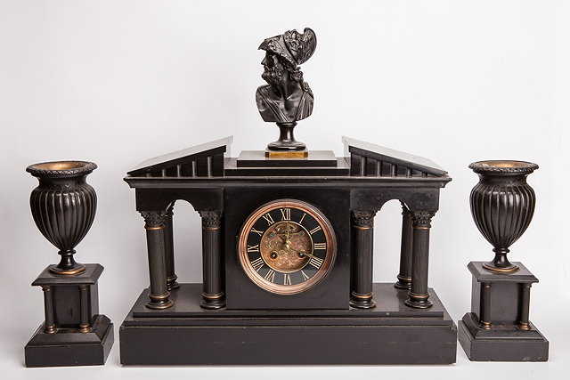 Appraisal: A VICTORIAN BLACK SLATE CLOCK GARNITURE the central clock with