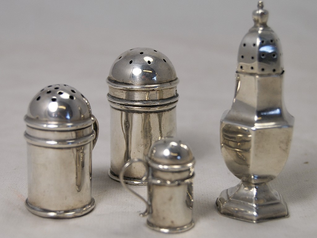 Appraisal: Two silver peppers in form of Jersey cans one Birmingham