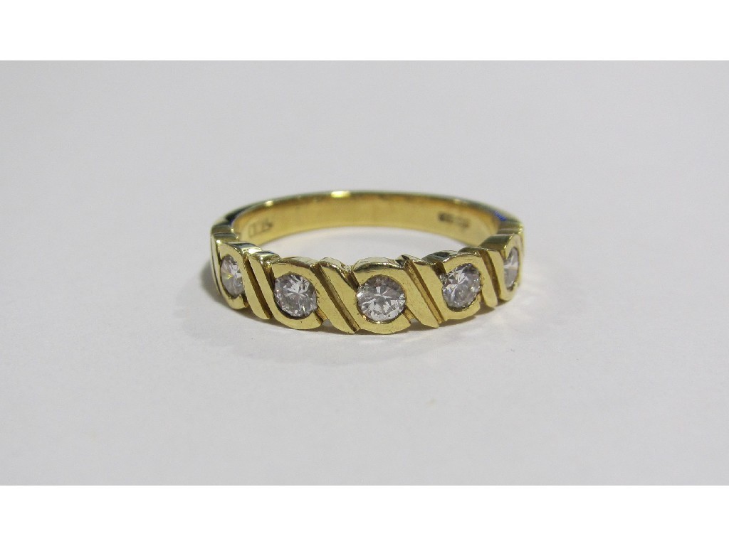 Appraisal: An eighteen carat gold diamond five stone half hoop ring