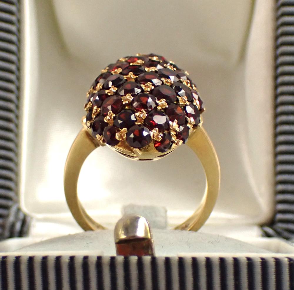 Appraisal: ITALIAN MADE GARNET AND EIGHTEEN KARAT GOLD RING with an