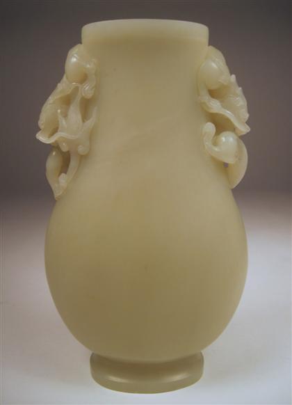 Appraisal: Chinese celadon jade vaseOf flattened baluster form with detailed carved