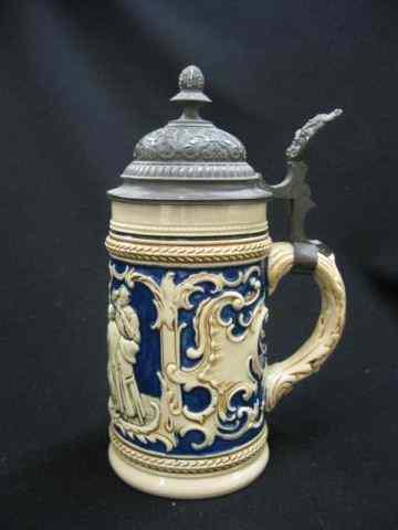 Appraisal: German Pottery Stein bas-relief festivescene cobalt trim '' tall excellent