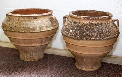 Appraisal: A near pair of Spanish terracotta olive jars of bulbous