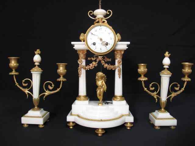 Appraisal: French carved marble mantle clock and candelabras Ormolu mounts and