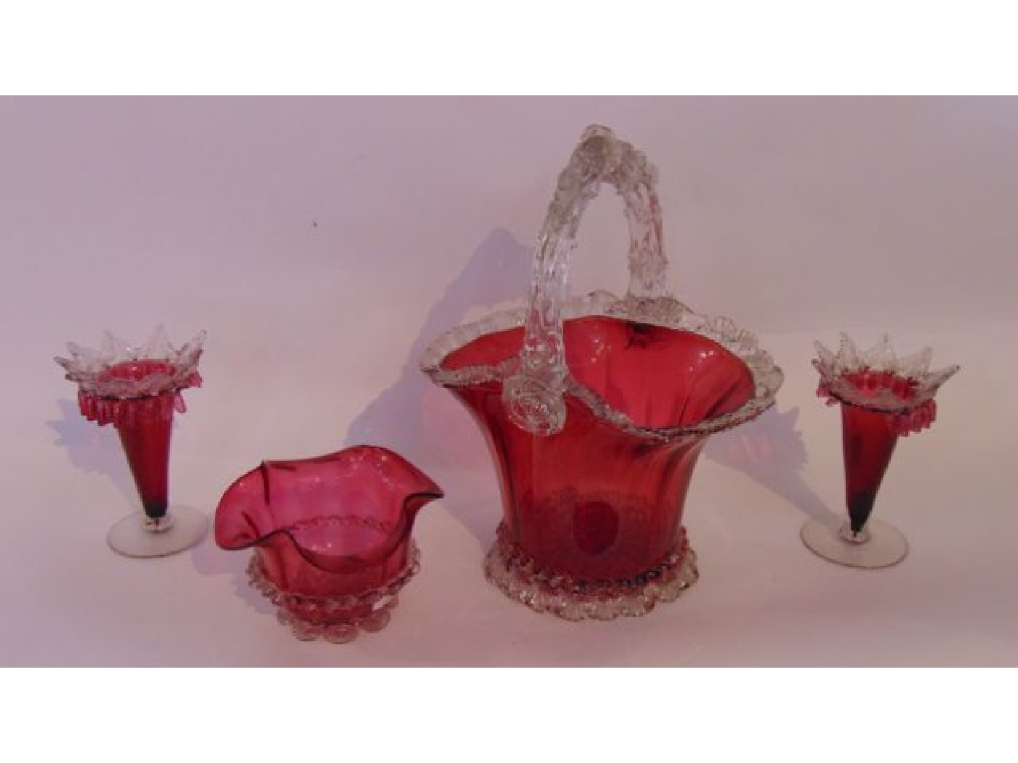 Appraisal: A Victorian cranberry glass basket with applied shaped clear glass