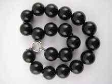 Appraisal: An onyx bead necklace beads approx mm with white metal