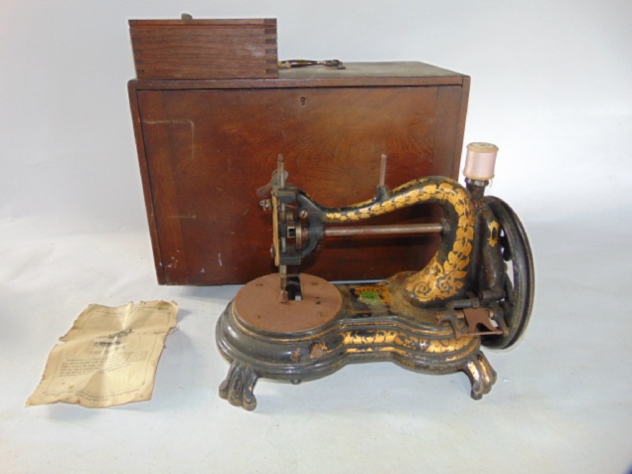 Appraisal: An antique sewing machine with all over ebonised finish and