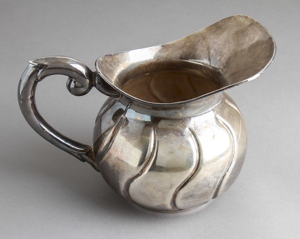 Appraisal: Sterling Silver Repousse Water Pitcher Sterling silver repousse water pitcher