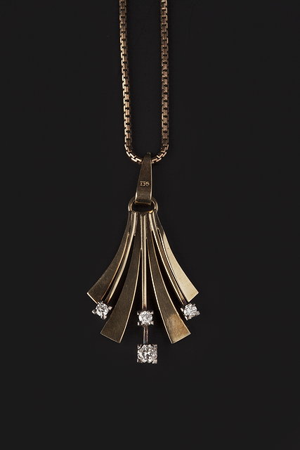 Appraisal: A DIAMOND SET PENDANT ON CHAIN the pierced flared panel