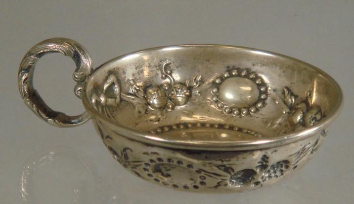 Appraisal: French silver wine taster repousse floral border th century TO