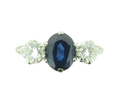 Appraisal: A sapphire and diamond three stone ring The oval shaped