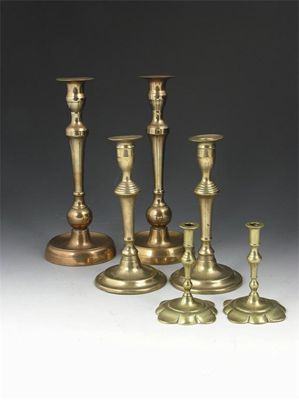 Appraisal: A pair of th century brass candlesticks with push up