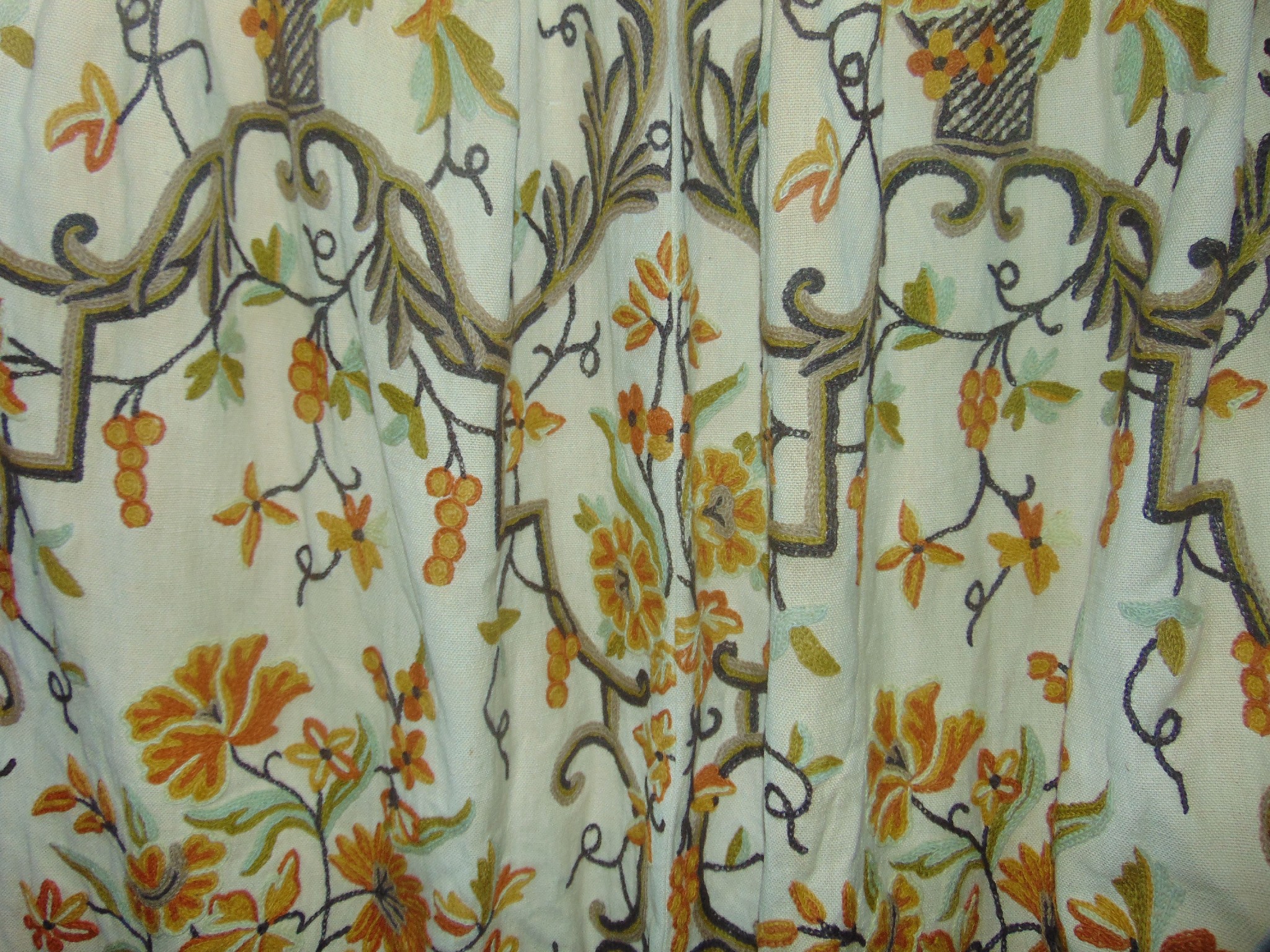 Appraisal: A pair of long crewel work lined curtains with floral