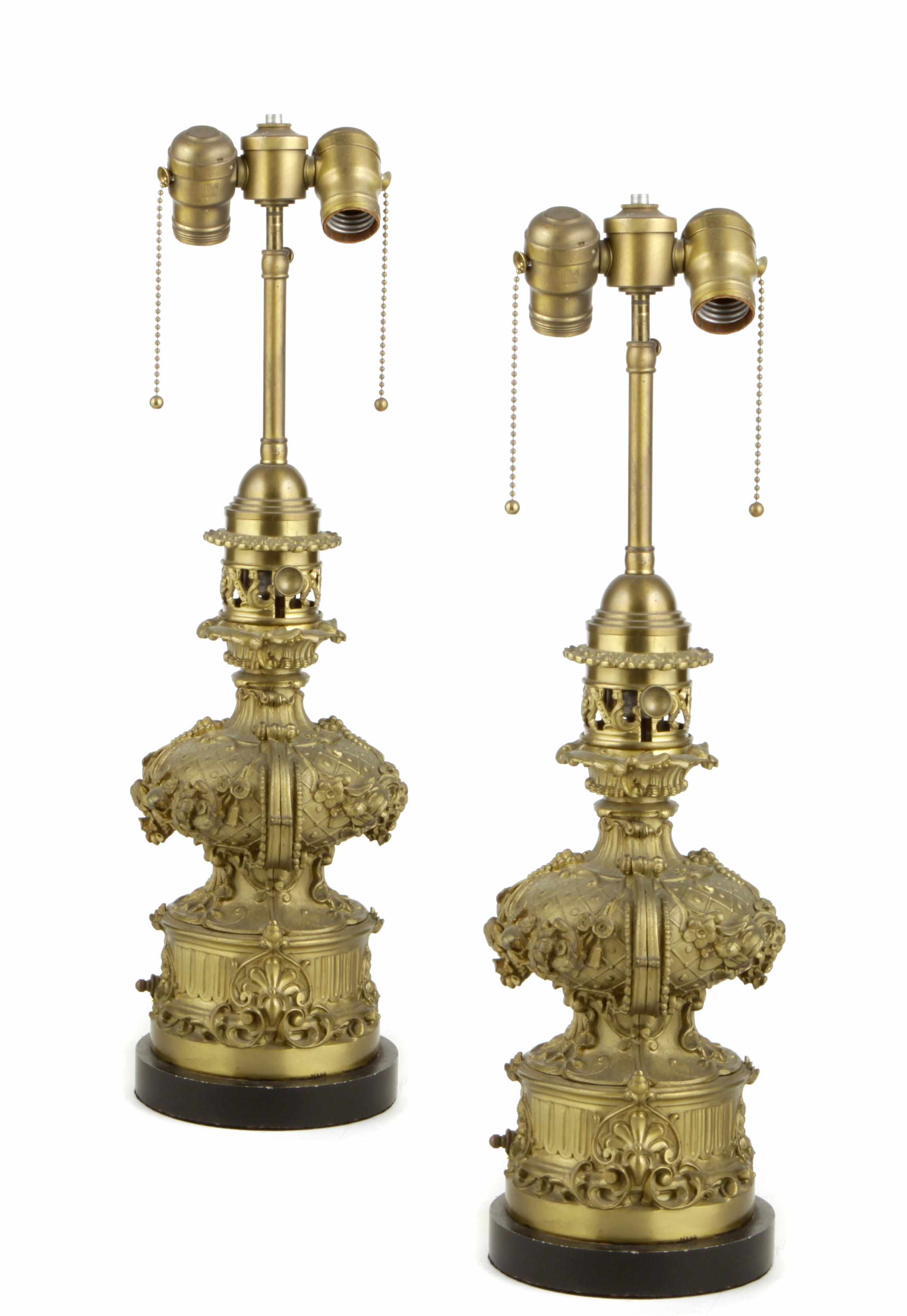 Appraisal: A pair of gilt brass floral decorated baluster form oil