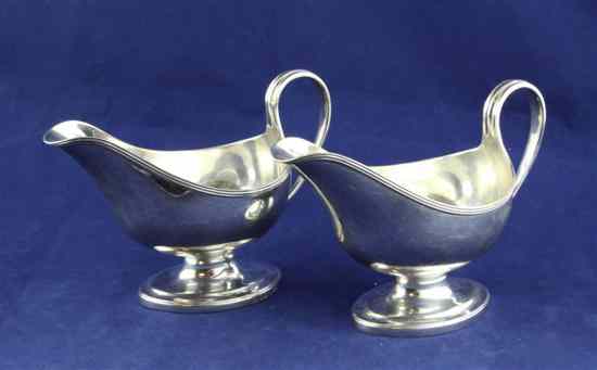 Appraisal: A pair of George III silver pedestal sauceboats with engraved