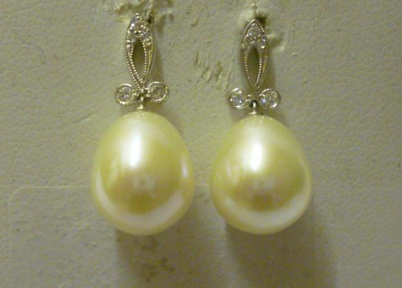 Appraisal: A PAIR OF CULTURED PEARL AND DIAMOND DROP EARRINGS the