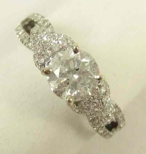 Appraisal: DIAMOND AND EIGHTEEN KARAT WHITE GOLD RING featuring a round