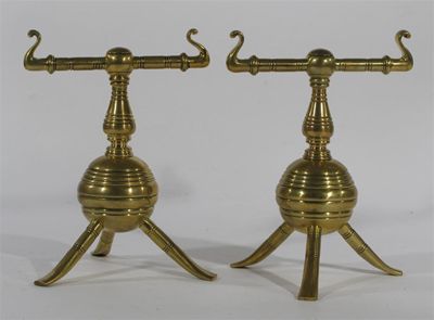 Appraisal: A pair of Aesthetic Movement brass fire dogs probably Benham