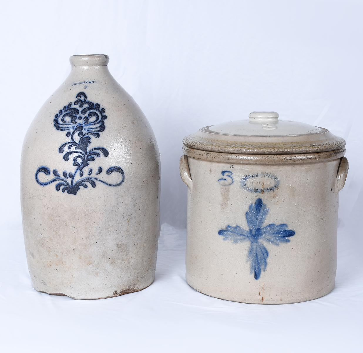 Appraisal: DECORATEDE AMERICAN STONEWARE JUGS Comprising - Three gallon lidded crock