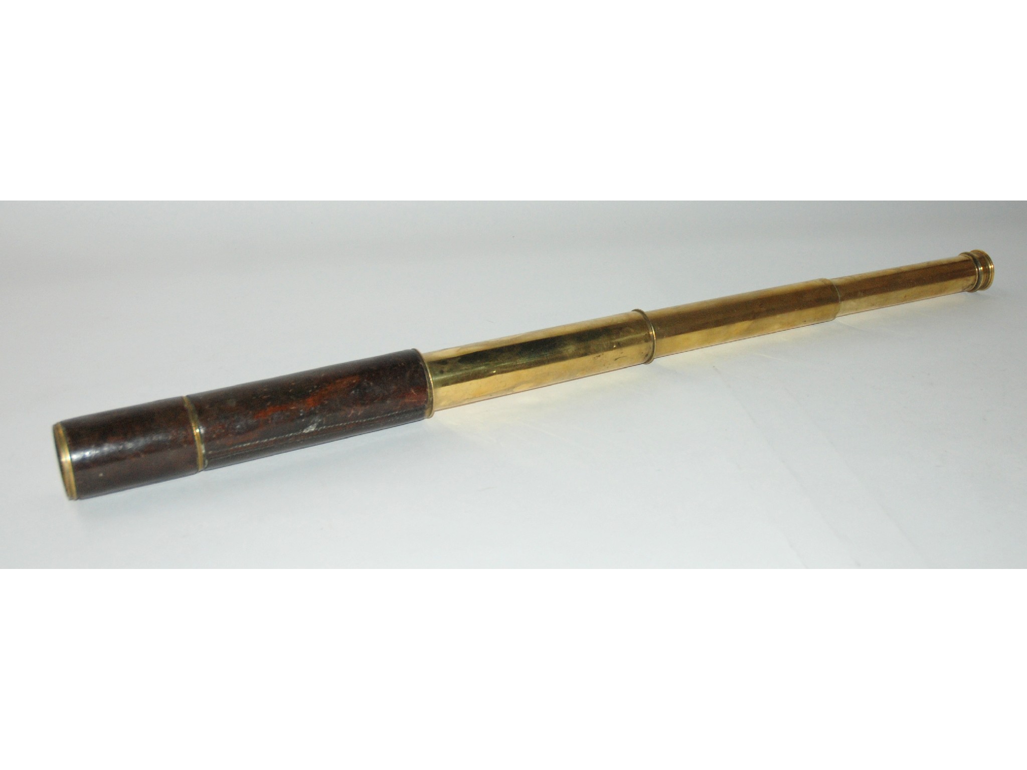 Appraisal: A brass three draw telescope by Steward London in leather