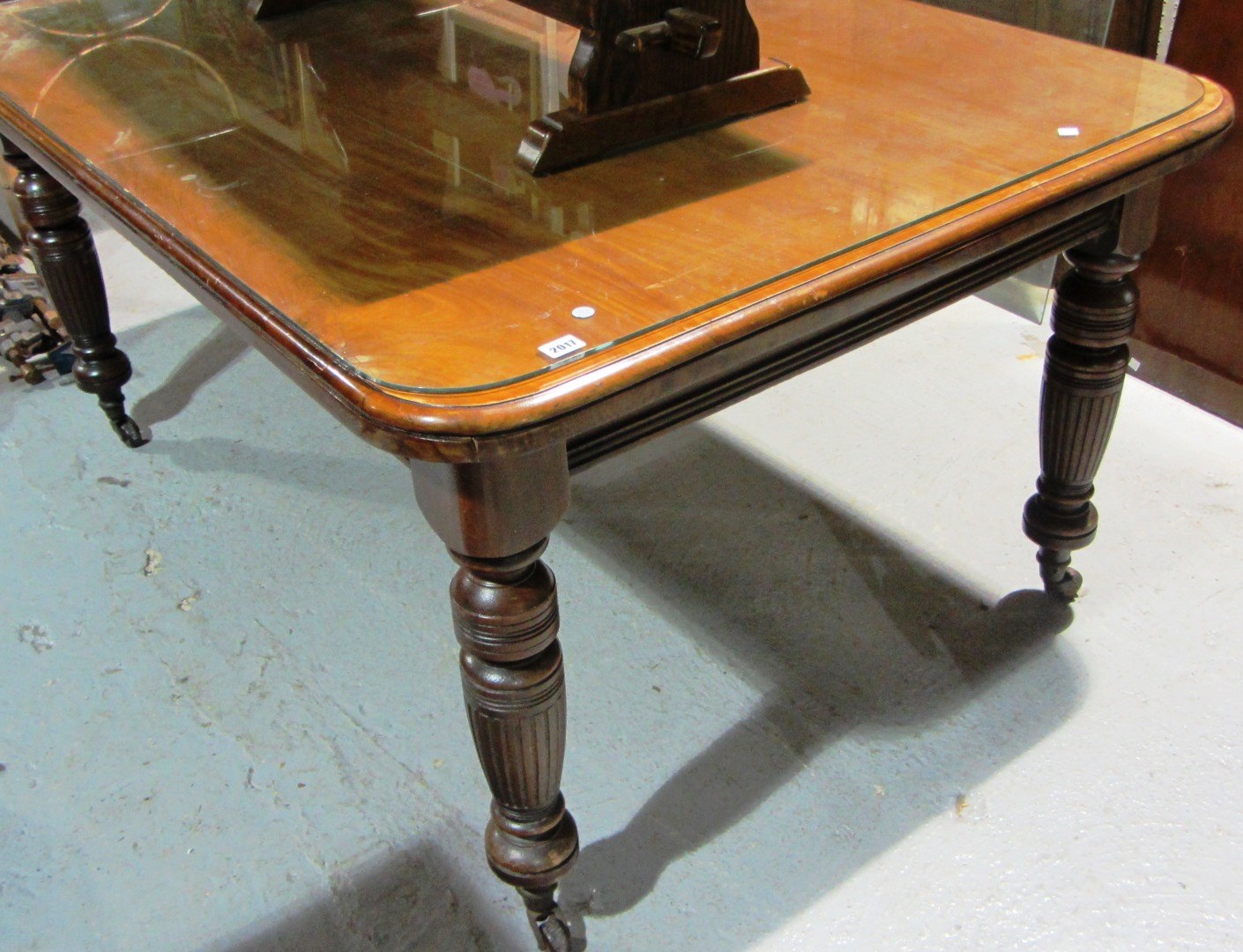 Appraisal: A th century mahogany rectangular dining table on turned supports