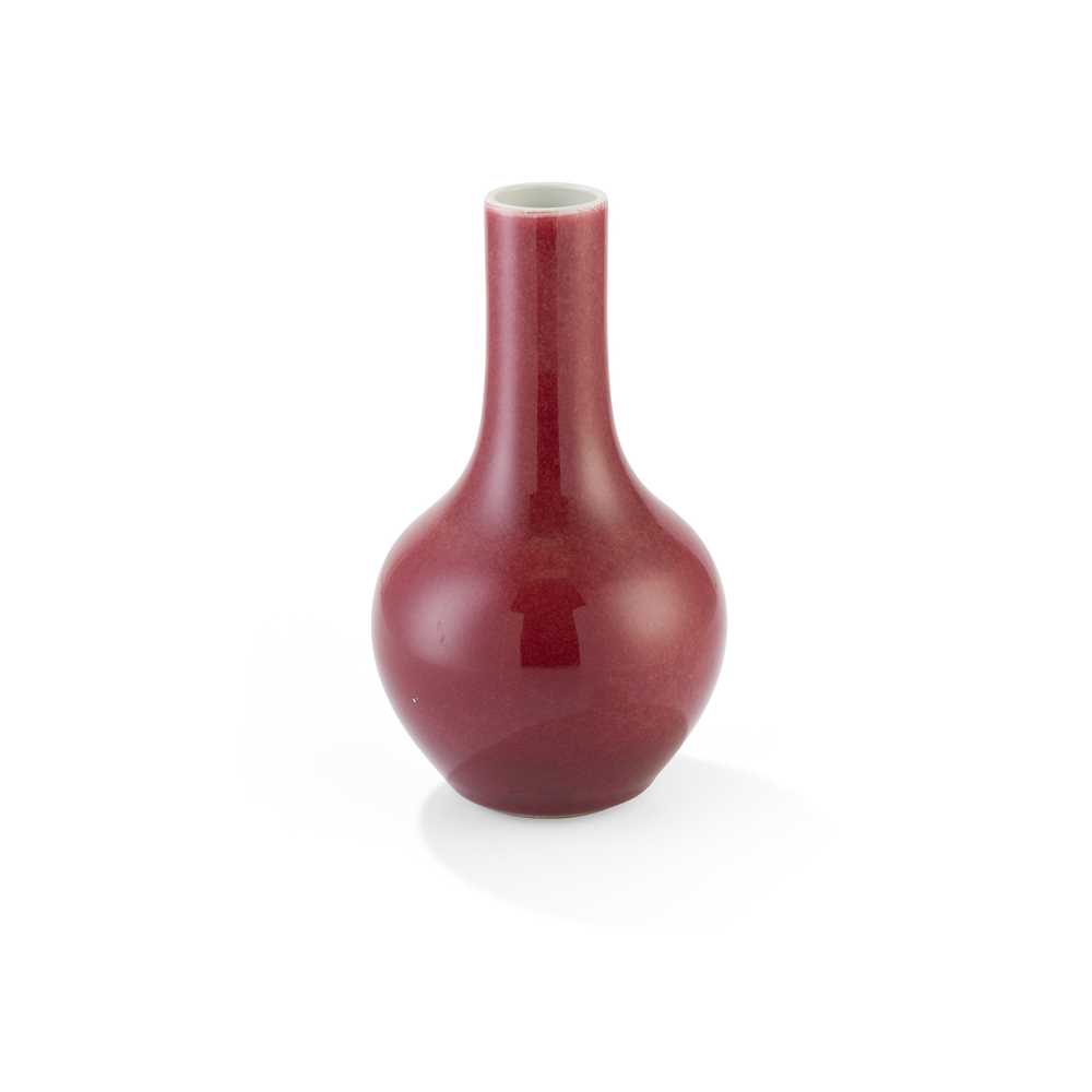 Appraisal: RED-GLAZED BOTTLE VASE potted on a recessed foot rising to