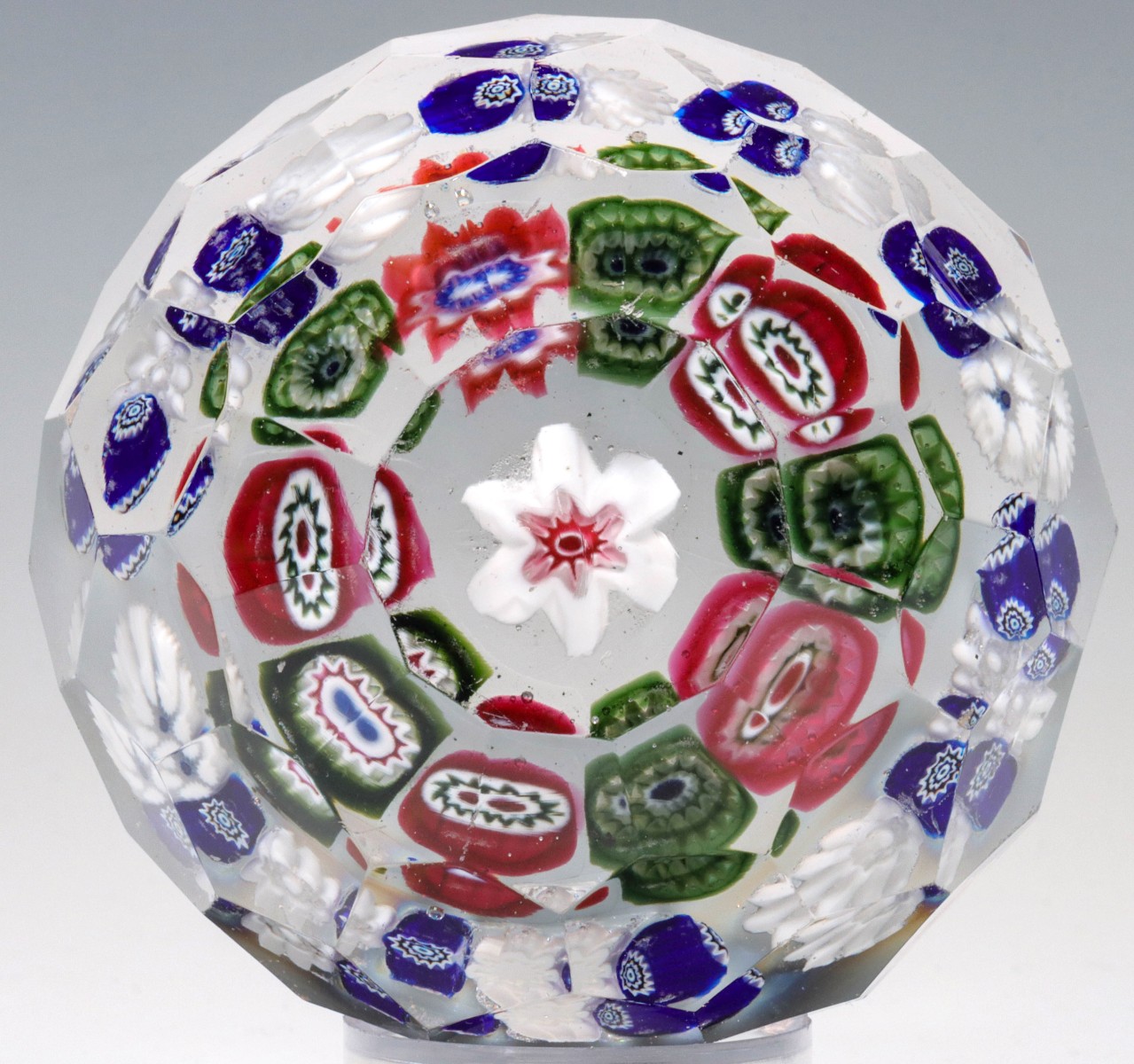 Appraisal: ANTIQUE PAPERWEIGHT WITH MILLEFIORI POSSIBLY BOHEMIANThe colorless glass weight with