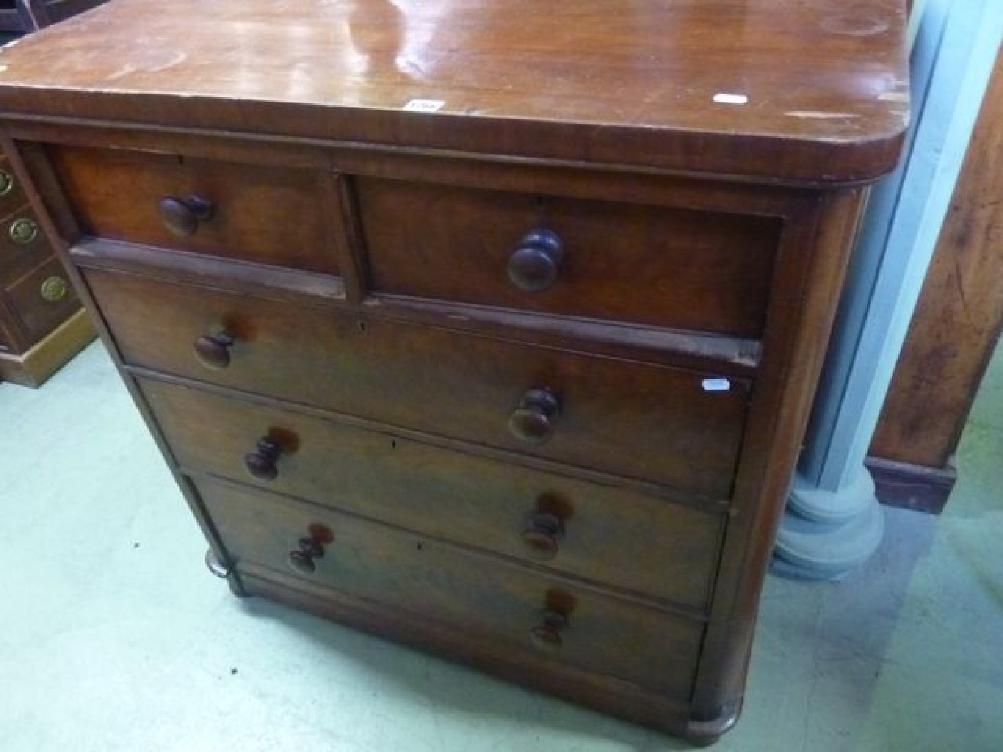 Appraisal: A Victorian mahogany veneered bedroom chest of three long and