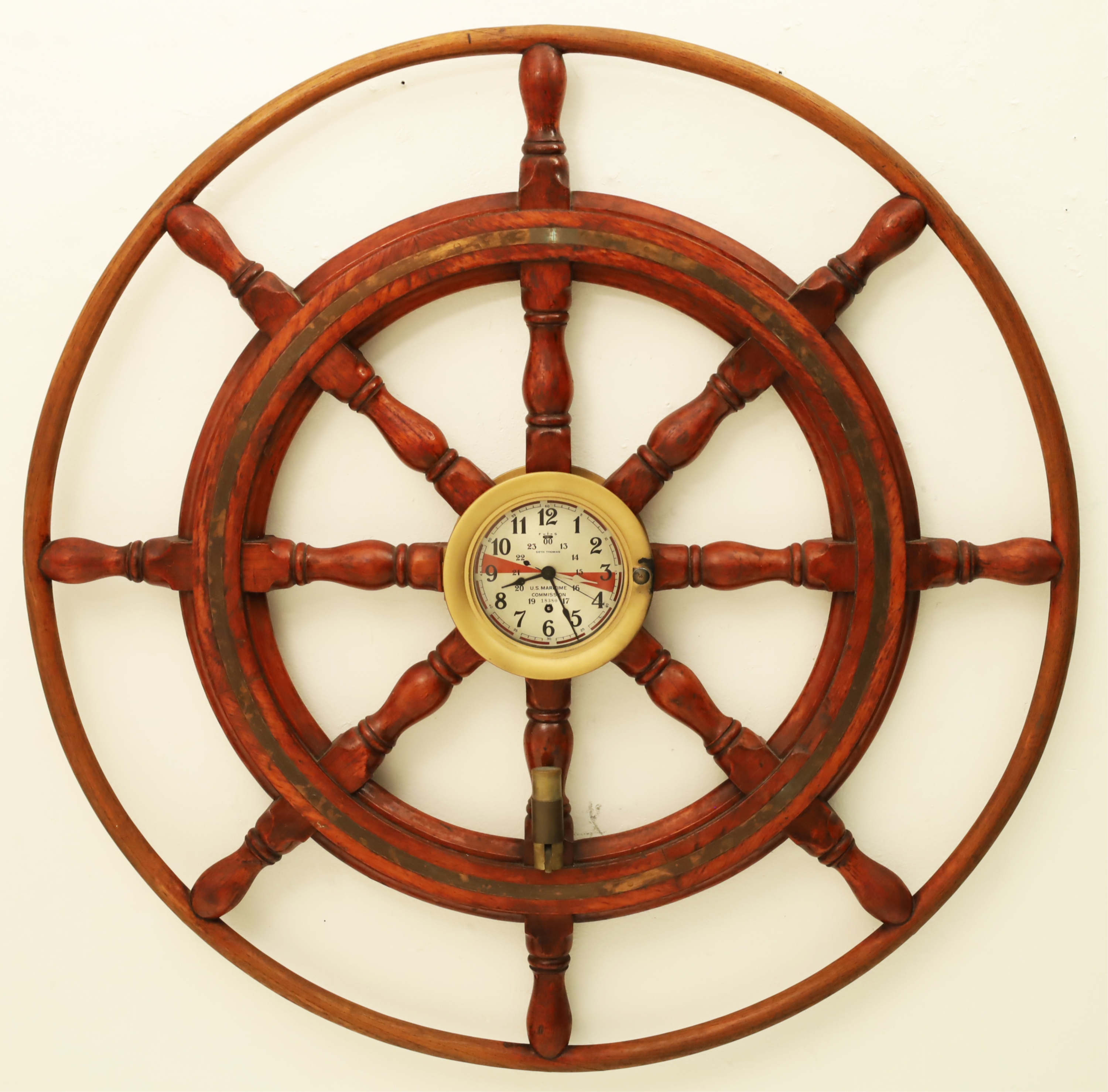 Appraisal: SETH THOMAS SHIP WHEEL MOUNTED CLOCK Mahogany and brass inlaid