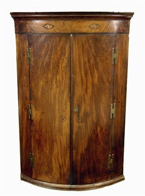 Appraisal: A George III mahogany bowfront hanging corner cupboard fitted with