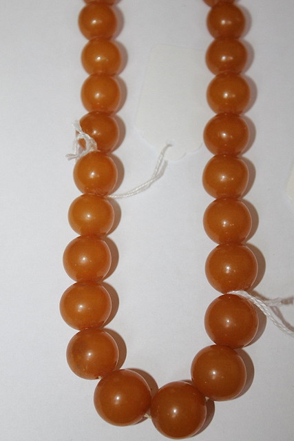 Appraisal: A GRADUATED AMBER NECKLACE of honey colour grams